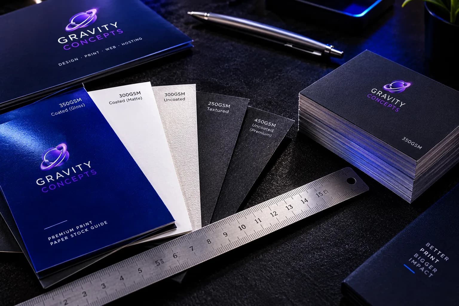 A fan of paper stock samples spread on a designer's desk for weight and texture comparison.