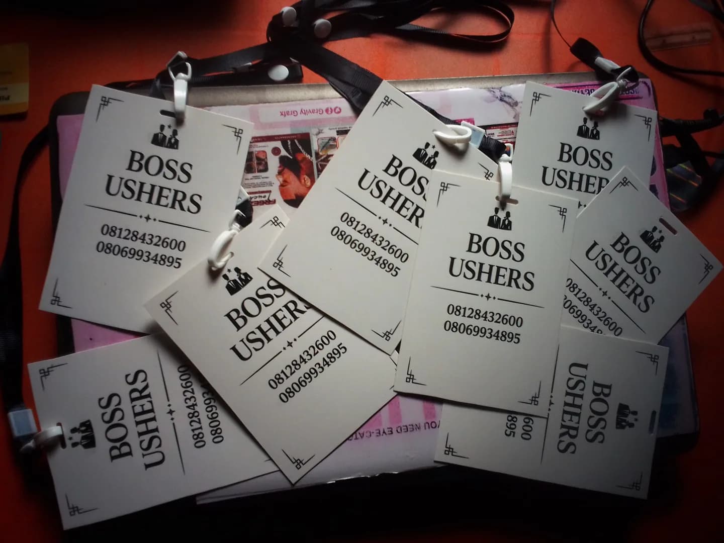 Boss Ushers event ID cards and lanyards showing brand design and print-ready production output.